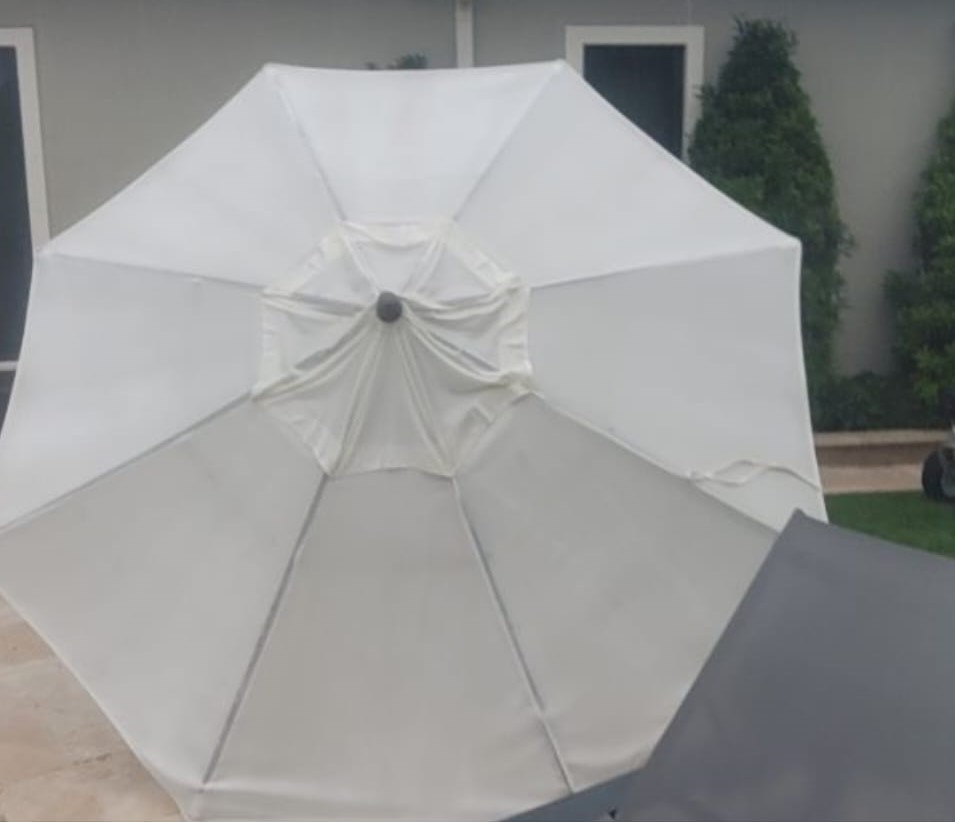 Outdoor patio umbrella restored to a clean and bright appearance after professional cleaning