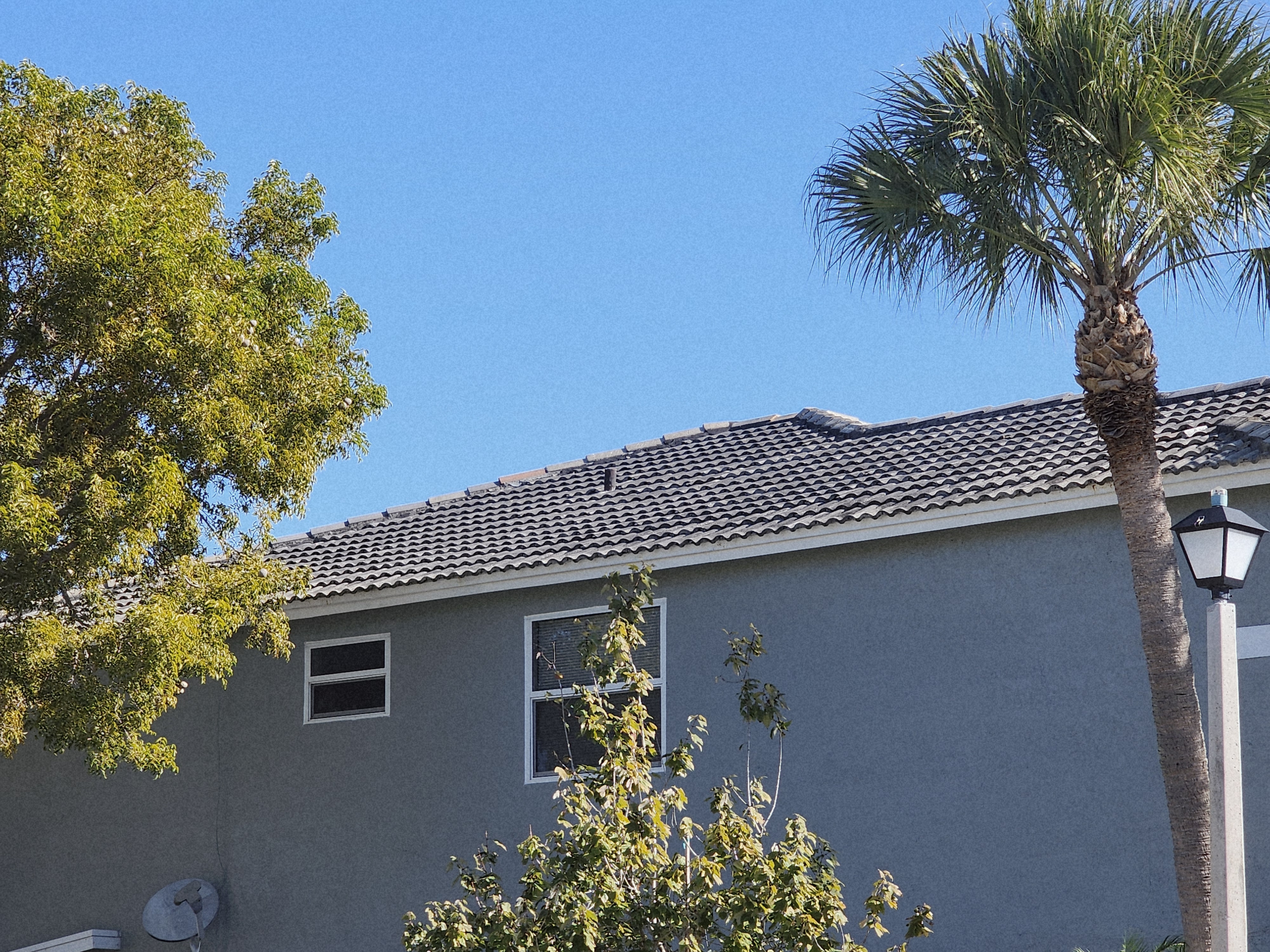Excelsior before roof pressure cleaning in Pompano Beach, FL, removing buildup and restoring a clean, well-maintained roof surface