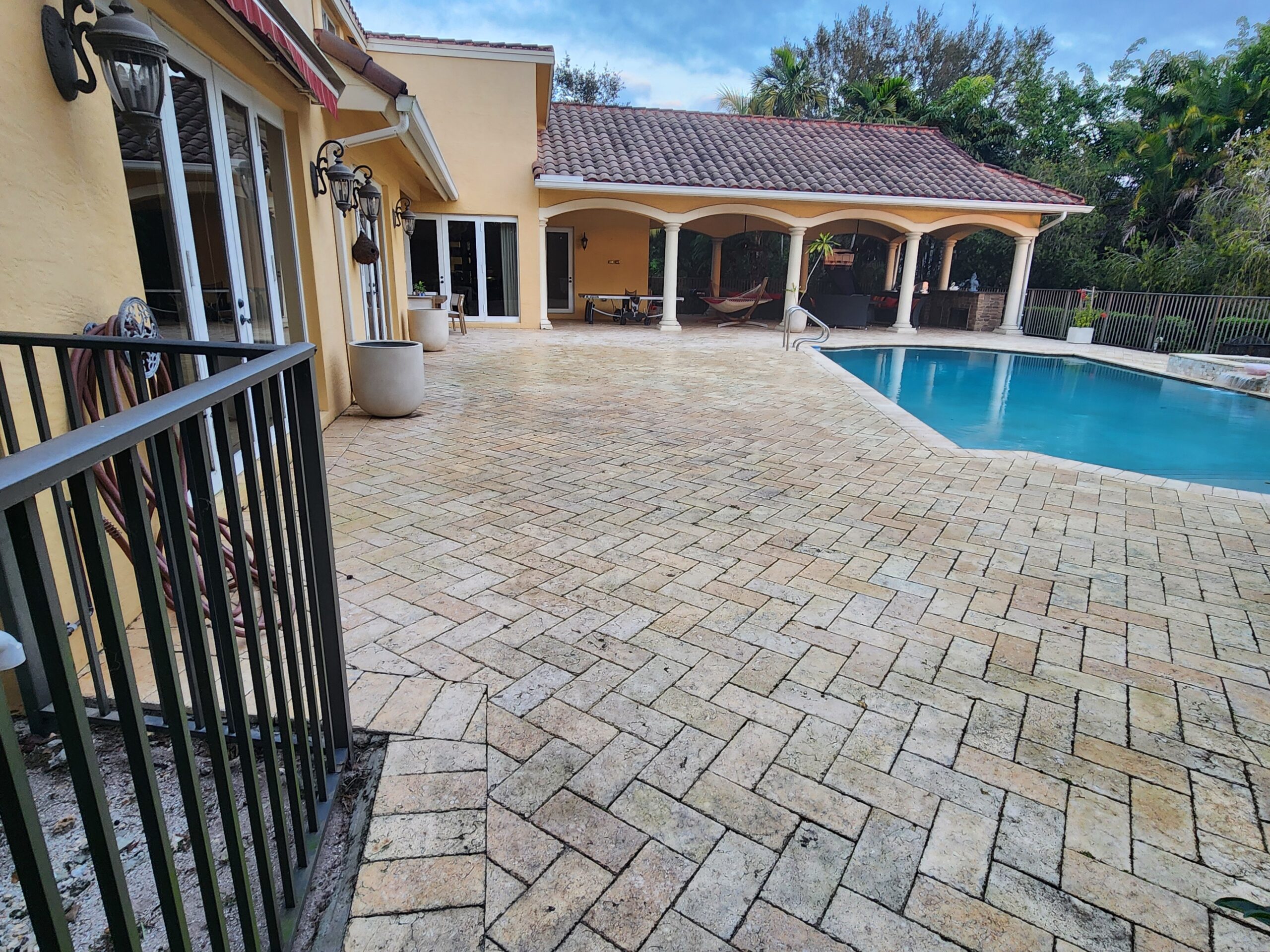 Roof, pool deck, and patio surfaces heavily stained and covered with mold, algae, and dirt before professional pressure cleaning in Parkland
