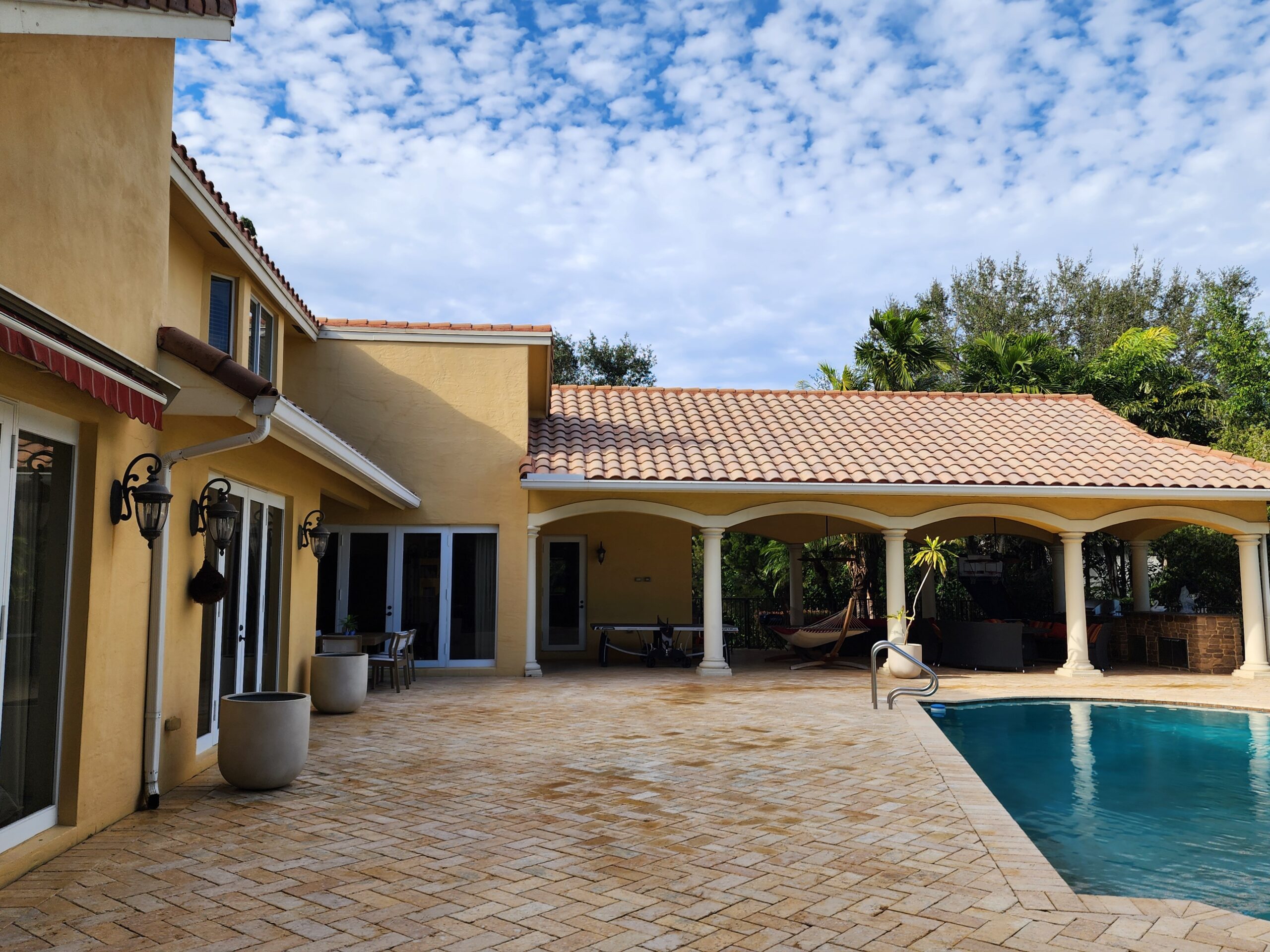 Roof, pool deck, and patio surfaces fully cleaned and restored after professional pressure cleaning in Parkland, with mold, algae, and dirt removed