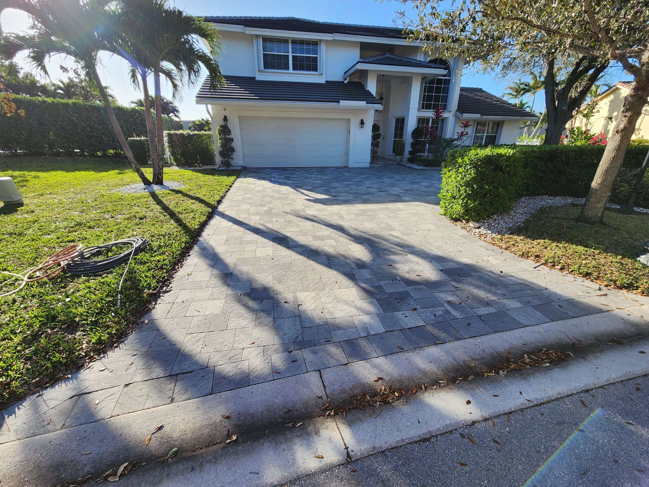 Driveway pressure cleaning in Boca Raton by Excelsior before professional surface restoration