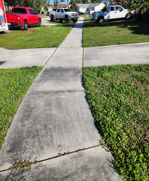 Before Sidewalk power cleaning in Boca Raton with visible algae, dark stains, and surface buildup before professional cleaning.