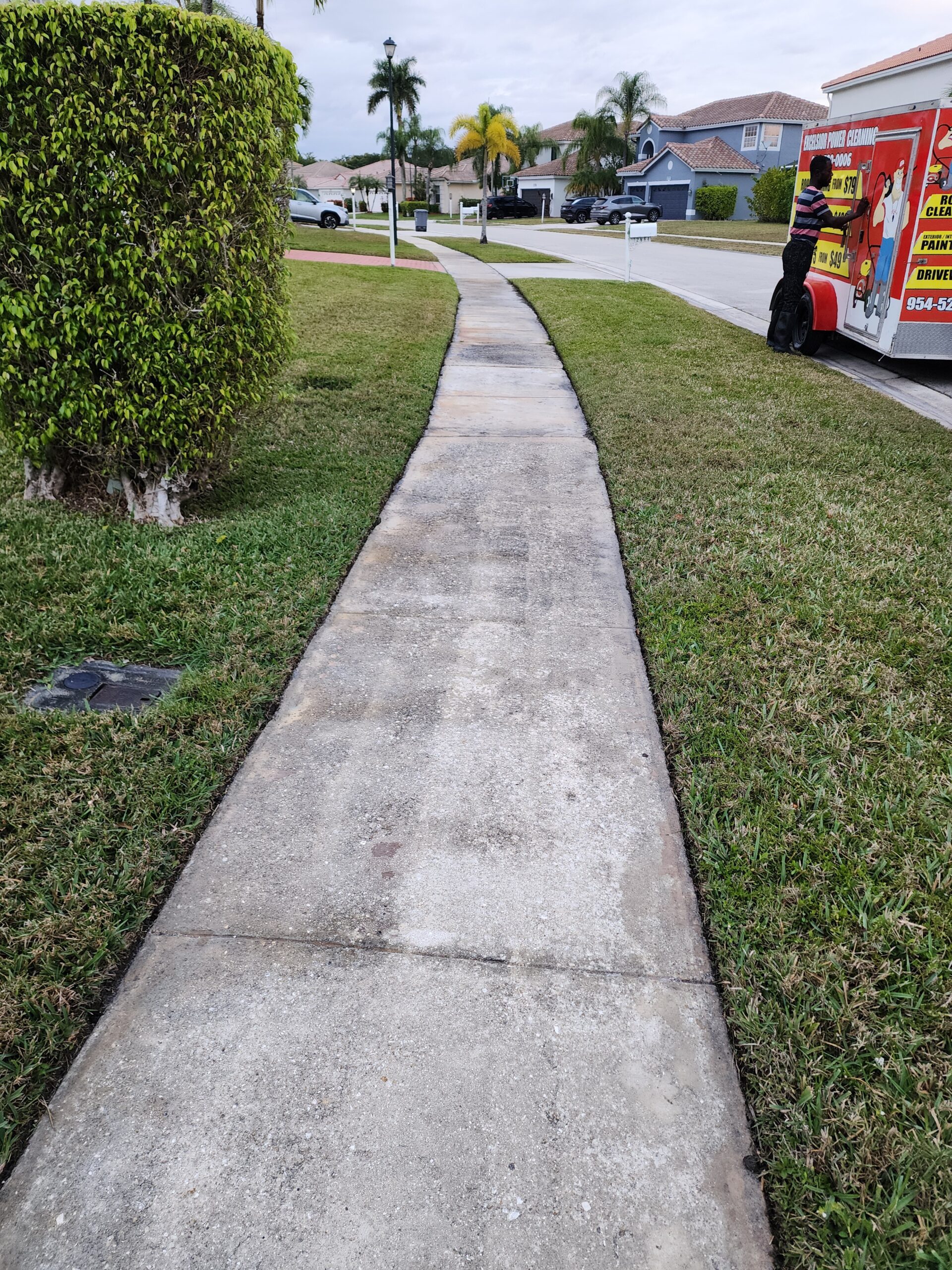 Before power cleaning of walkway in Boca Raton FL showing heavy dirt buildup, algae growth, and dark stains on residential concrete pathway